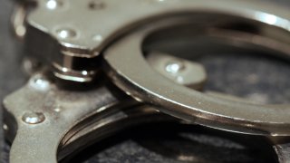 A close up shot of a pair of handcuffs on a table.