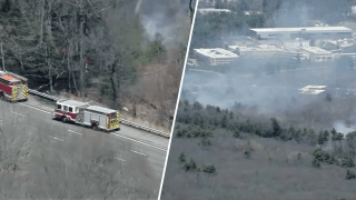 Firefighters responding to an apparent brush fire near Route 3 in Bedford, Massachusetts, on Friday, April 18, 2025.